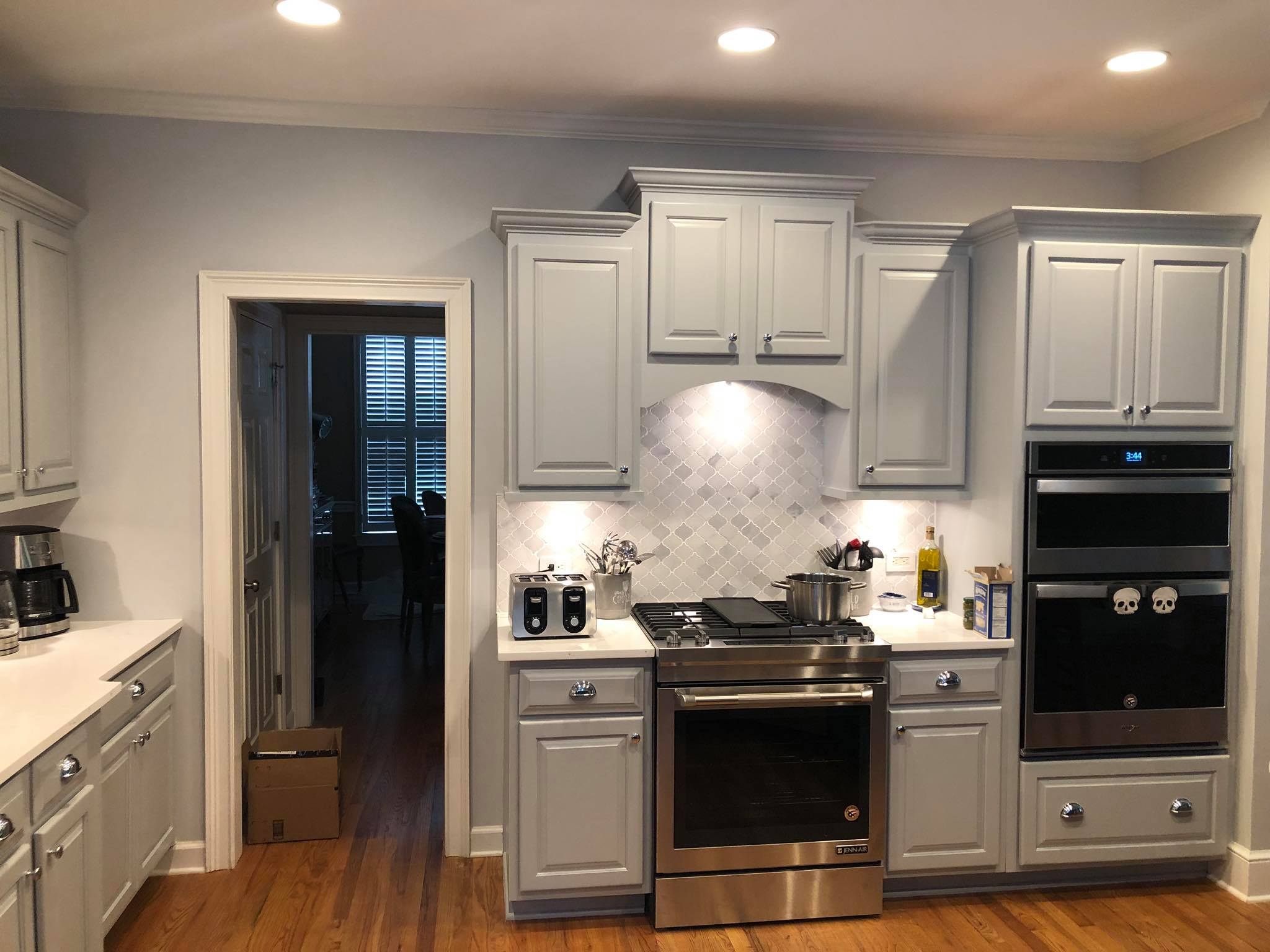 Full Kitchen Remodeling with Upper and Lower Cabinets Painted White Left View