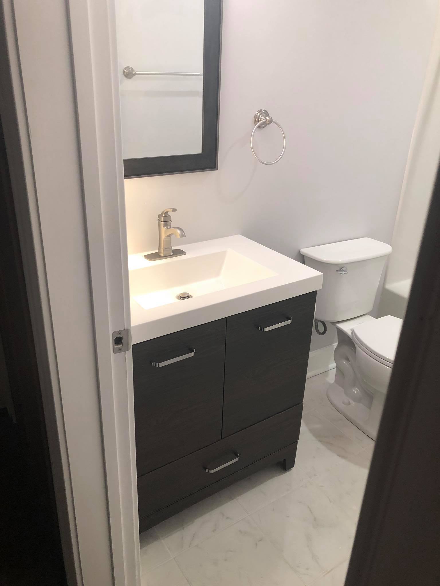 Completed Basement Bathroom Build and Installation with Vanity Tub and Shower 3