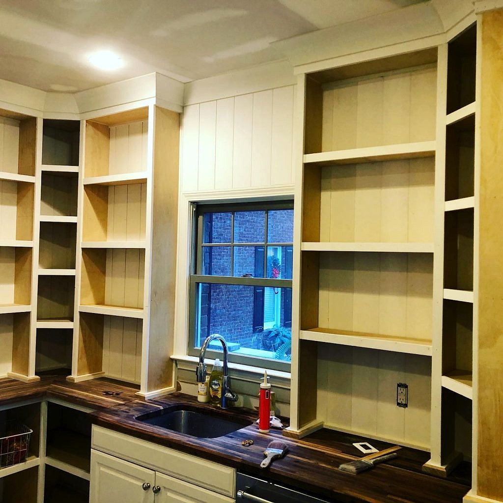 Custom Built in Cabinets with Top Trim and Bottom Shelving Installed and Painted White 7