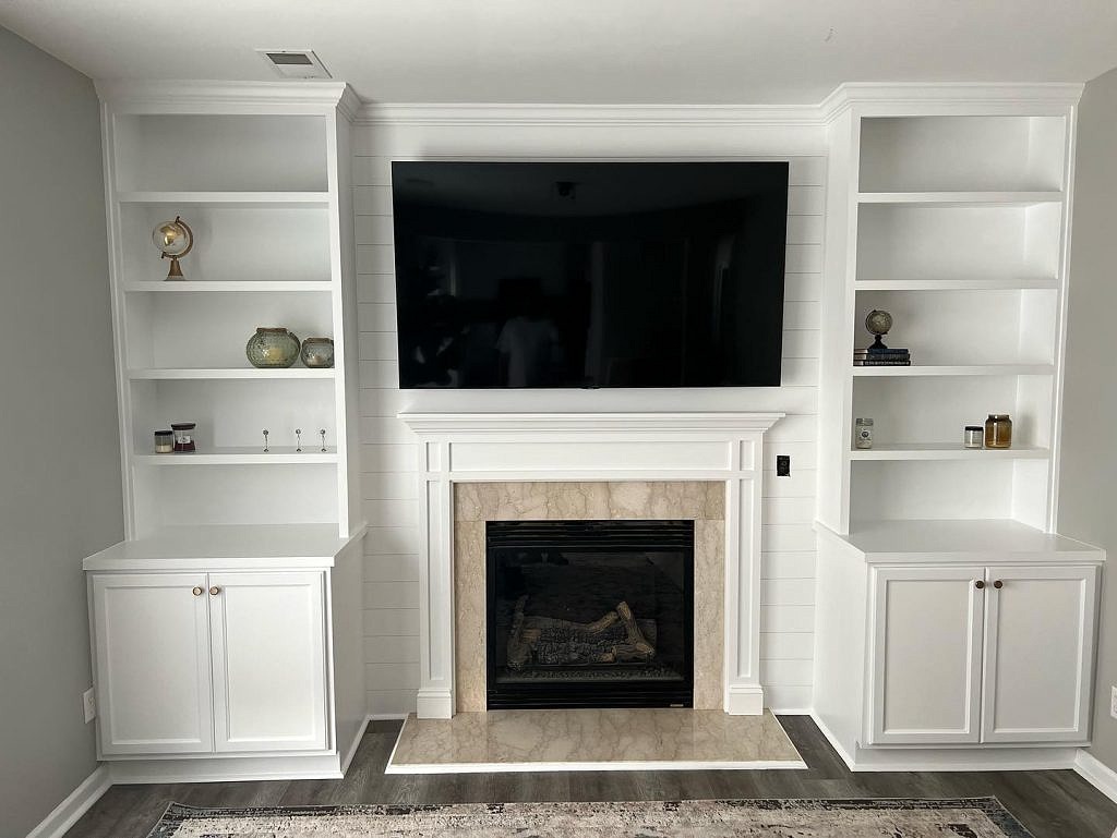 New builtin cabinets with bookshelves shiplap and fireplace trim 1